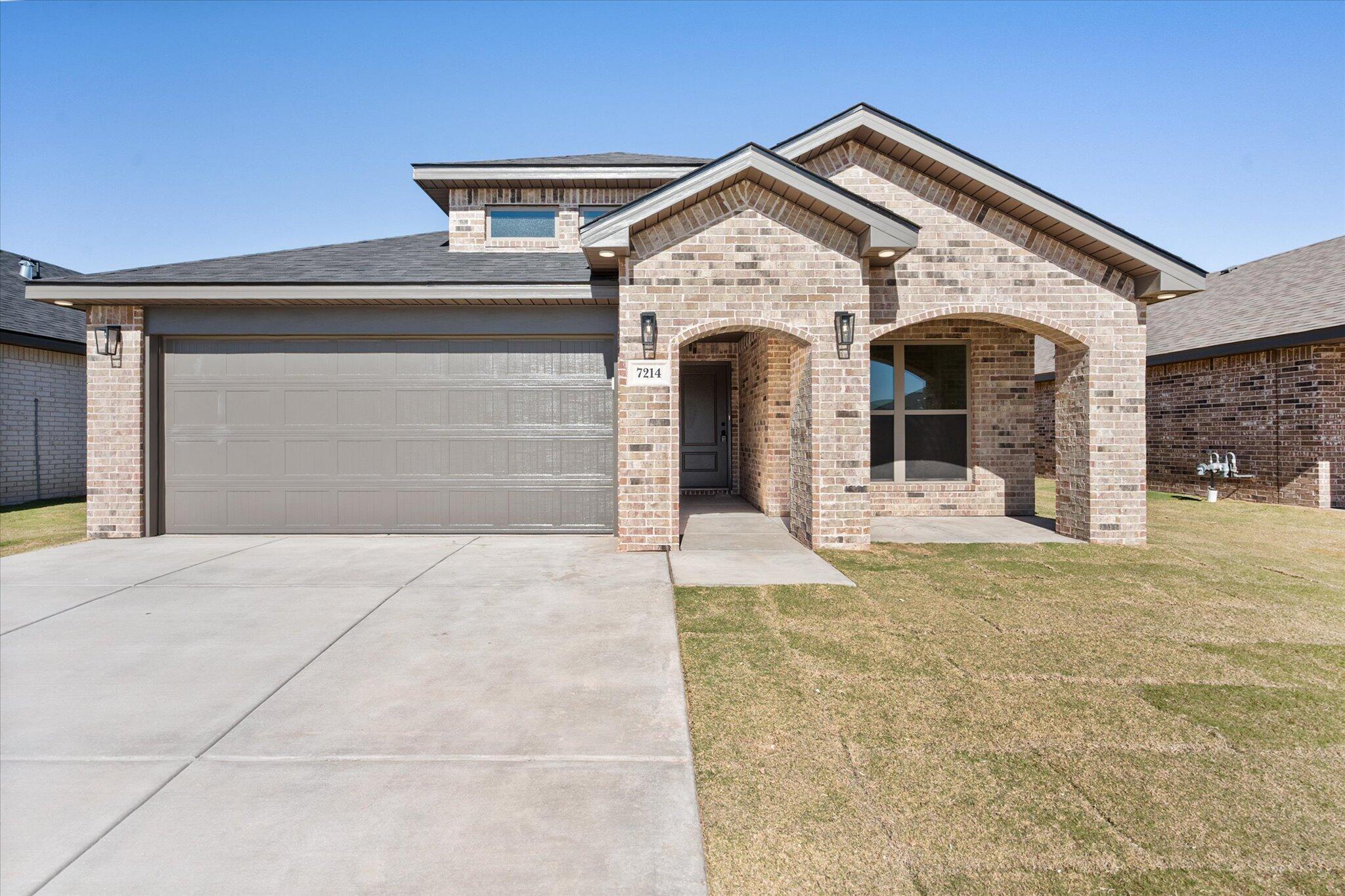 7214 8th Street Lubbock, TX 79416 - Photo 2 of 23 a front view of a house with a yard