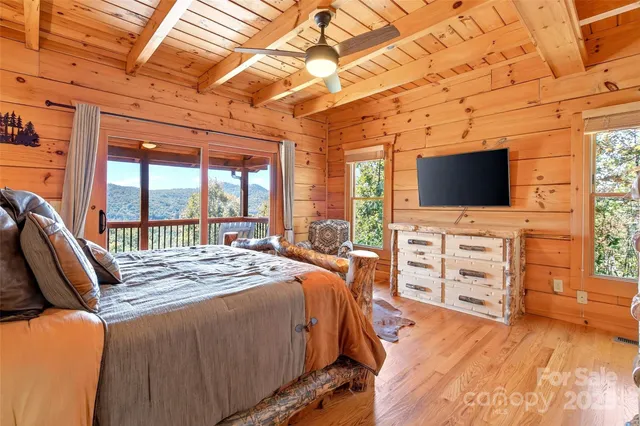 a bedroom with a bed and a large window