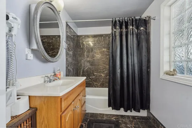 a bathroom with a sink a mirror and a shower