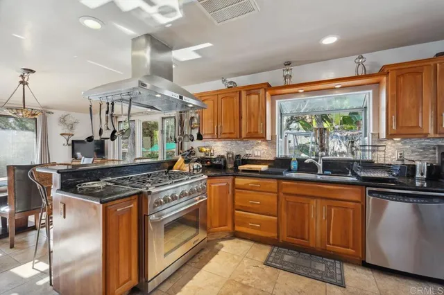 a kitchen with stainless steel appliances granite countertop a stove and a sink