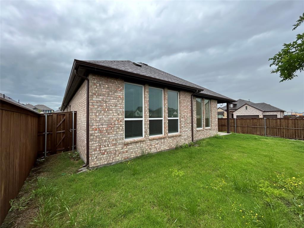 3314 Willena Road Melissa, TX 75454 - Photo 23 of 24 Expansive lawn area with a wood privacy fence and a gated entry