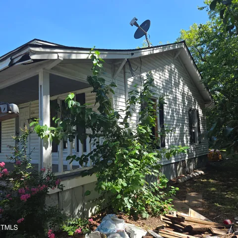 a yellow room with outdoor seating and flowers