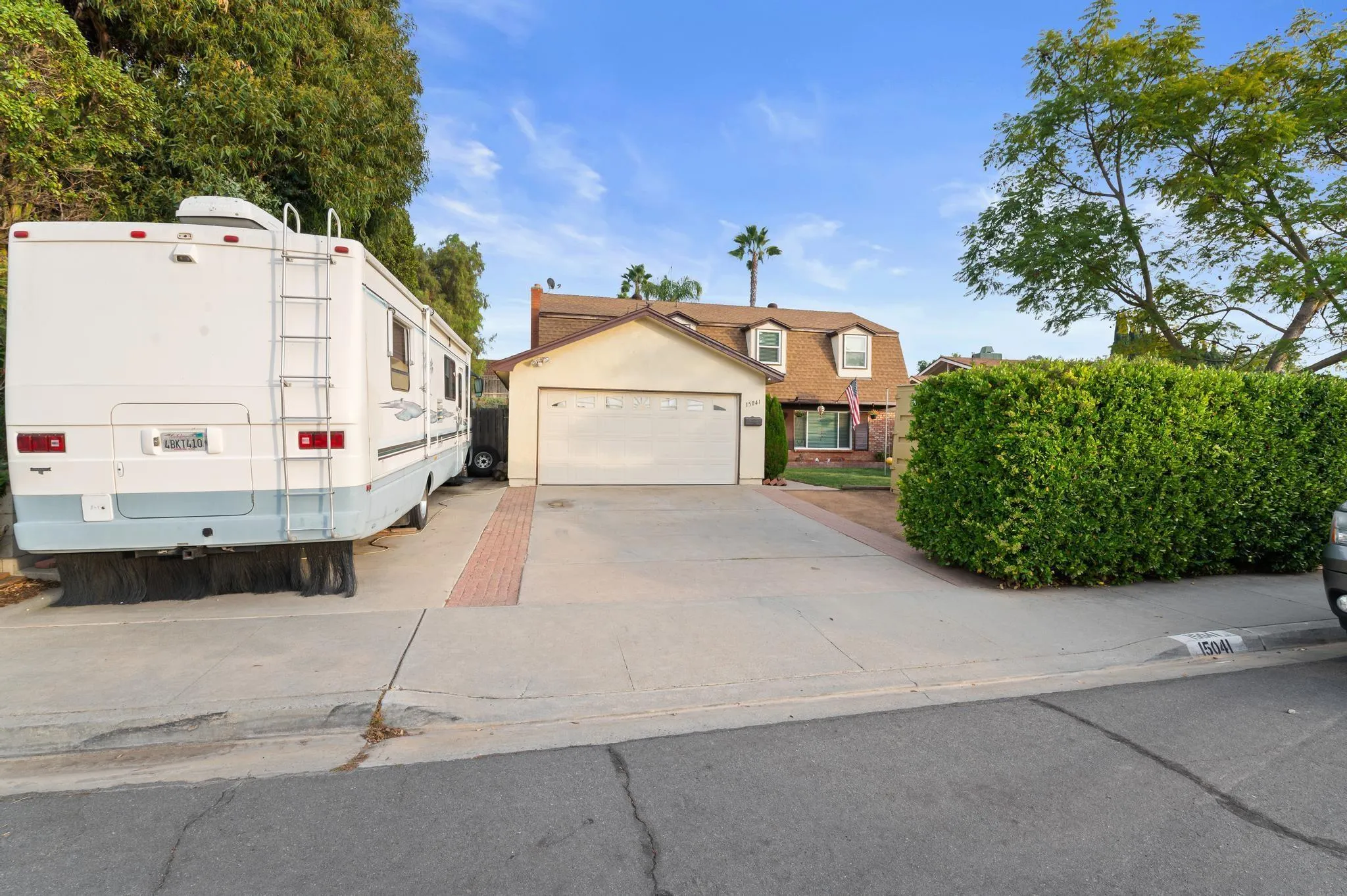 15041 Hesta Street Poway, CA 92064 - Photo 1 of 25 a large white building with a white fence next to a road