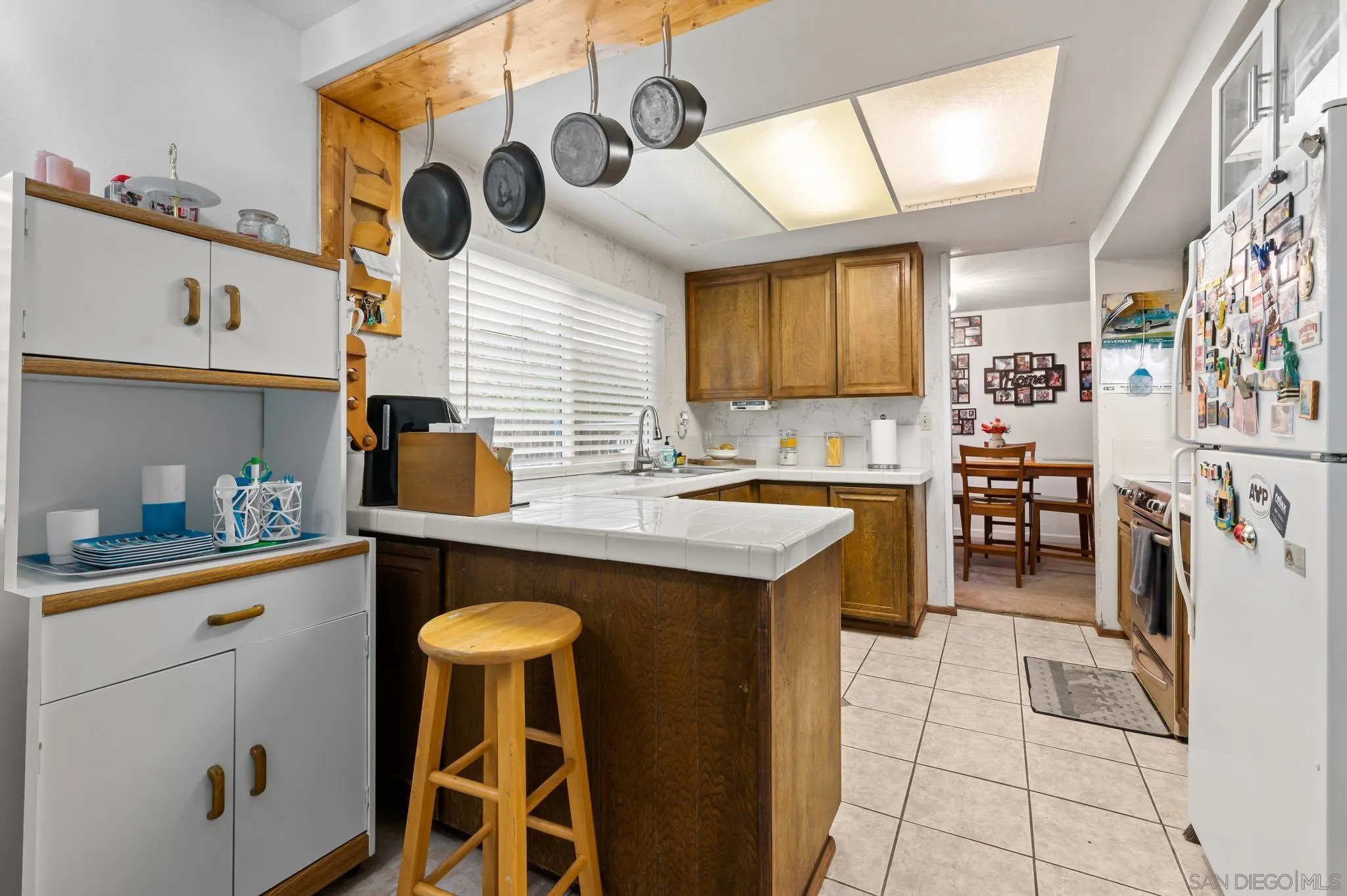 15041 Hesta Street Poway, CA 92064 - Photo 11 of 25 a kitchen with stainless steel appliances granite countertop a sink and a refrigerator