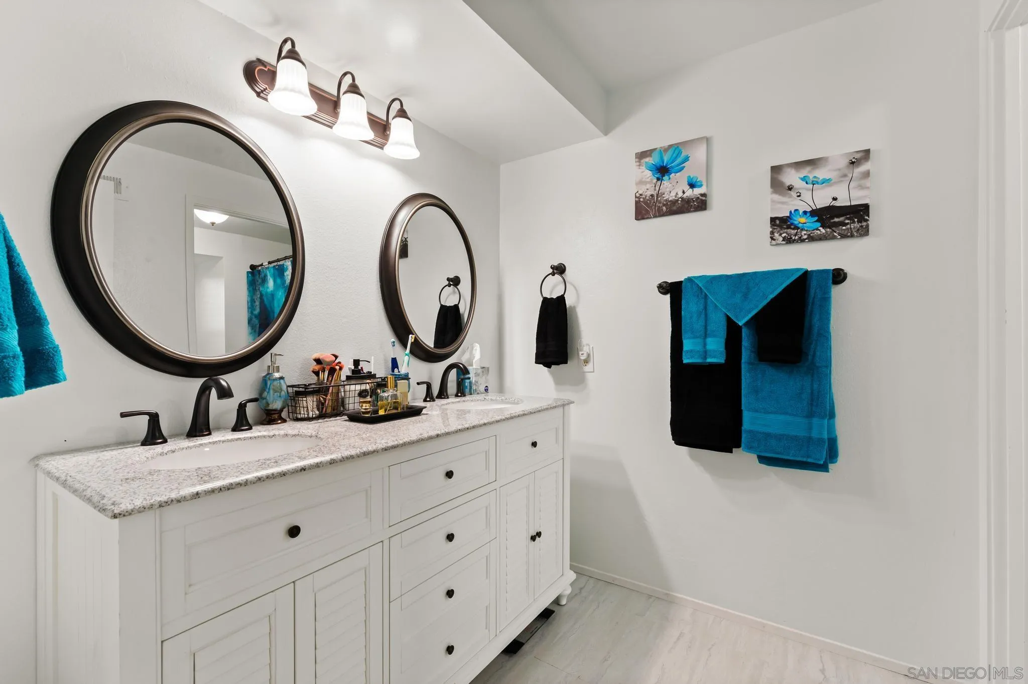 15041 Hesta Street Poway, CA 92064 - Photo 19 of 25 a bathroom with a double vanity sink and a mirror