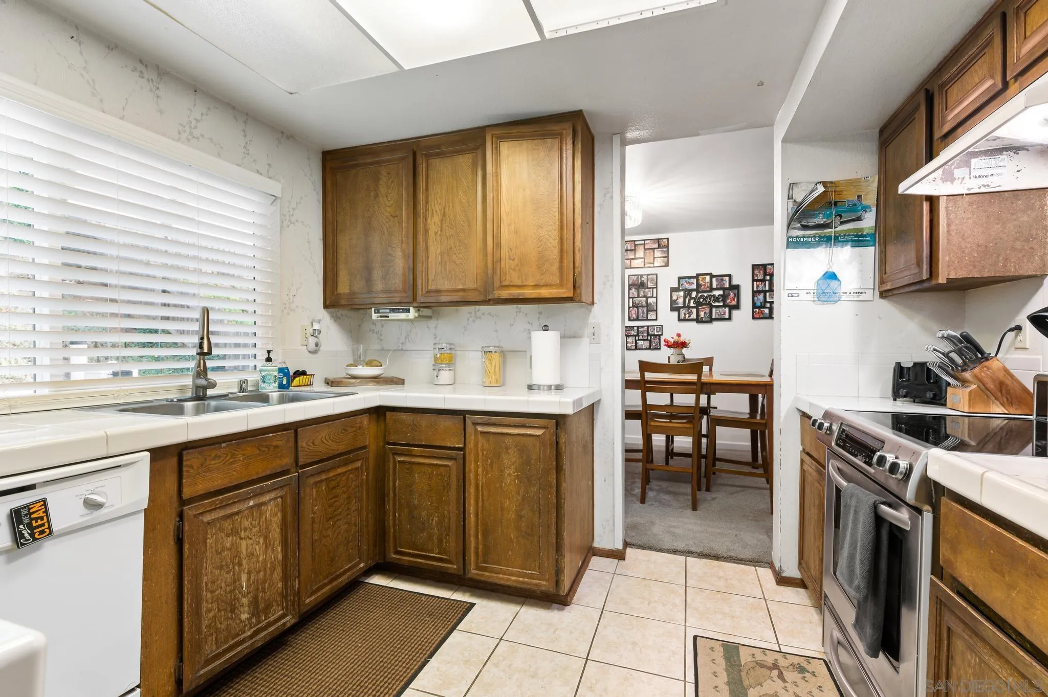 15041 Hesta Street Poway, CA 92064 - Photo 10 of 25 a kitchen with a sink stove and cabinets