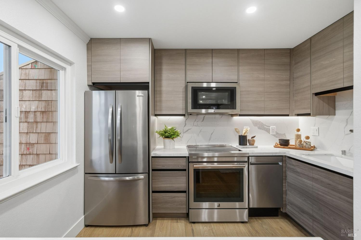 116 Stanford Way Sausalito, CA 94965 - Photo 13 of 37 a kitchen with a sink a refrigerator and cabinets