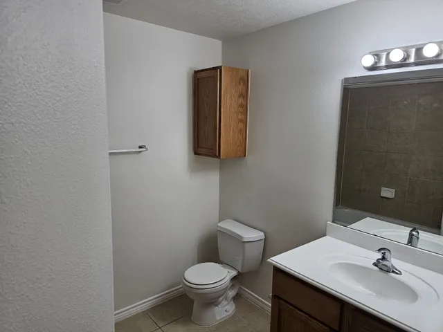 a bathroom with a sink toilet and mirror