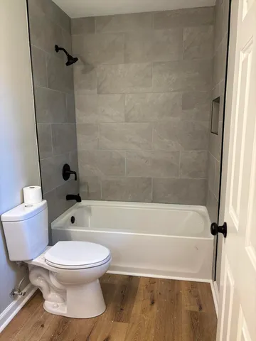 a bathroom with a toilet and a bath tub