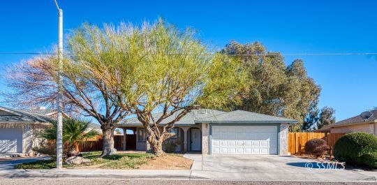 336 North Kern Street Ridgecrest, CA 93555 - Photo 1 of 35 a front view of a house with a yard and large trees