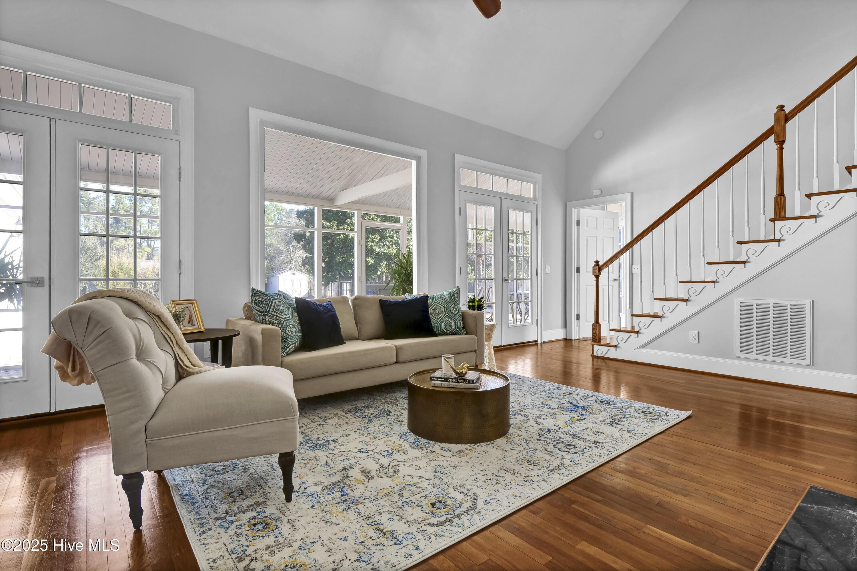 1307 Edgewater Club Road Wilmington, NC 28411 - Photo 16 of 55 Natural light flows into the living room through the expansive windows and doors.
