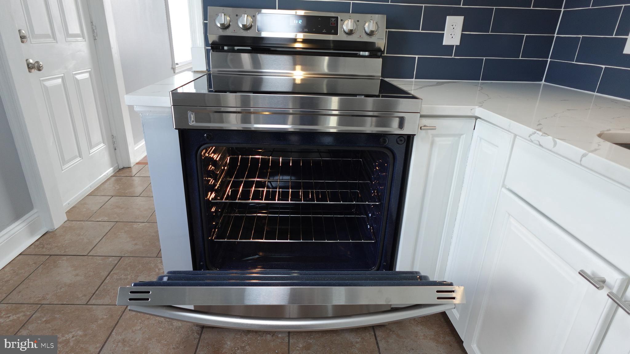 317 Devonshire Road Hagerstown, MD 21740 - Photo 10 of 114 a kitchen with a stove and a cabinet