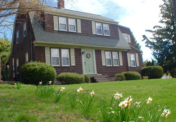18 Tilden Road Scituate, MA 02066 - Photo 1 of 30 a brick house with a large windows and a yard