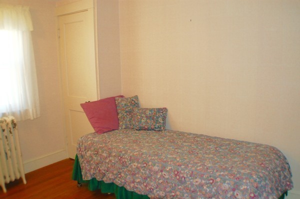 18 Tilden Road Scituate, MA 02066 - Photo 13 of 30 a bed sitting in a bedroom next to a small yard