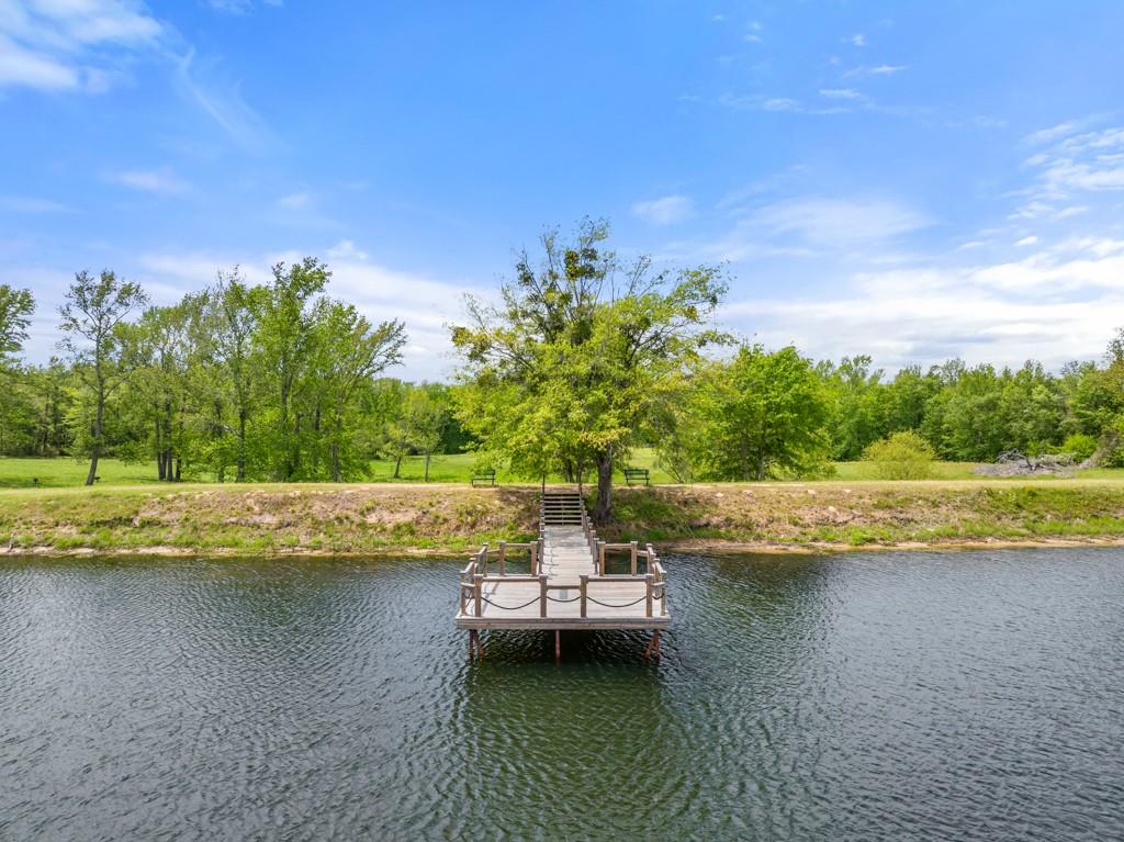 23630 Champion Drive Lindale, TX 75771 - Photo 33 of 36 a view of a lake with houses