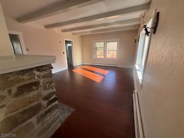 a view of kitchen and hallway with wooden floor