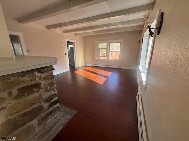 a view of kitchen and hallway with wooden floor
