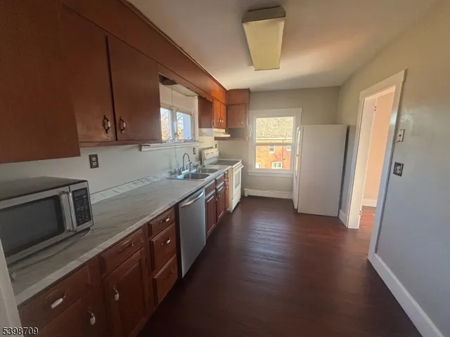 a kitchen with stainless steel appliances granite countertop a sink stove and cabinets