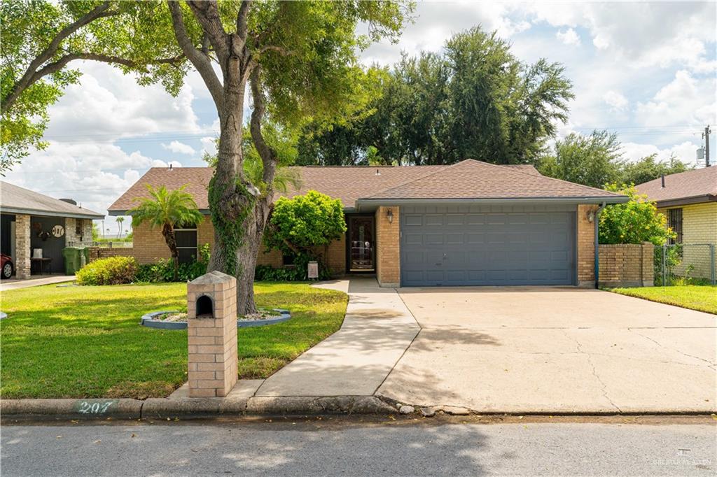 421 Becker Street Alamo, TX 78516 - Photo 1 of 1 Single story home featuring a garage and a front lawn