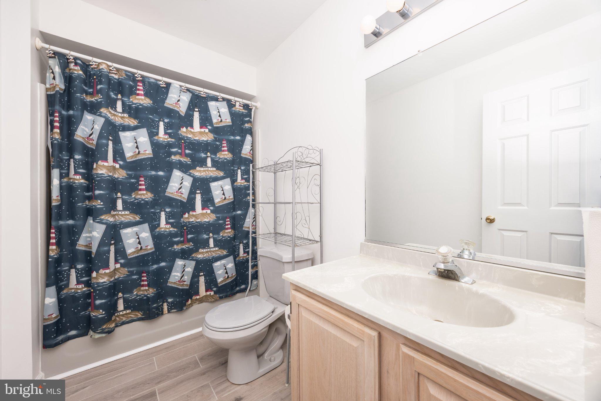10431 Brighton Road Ocean City, MD 21842 - Photo 9 of 39 Coastal charm in a serene bathroom.