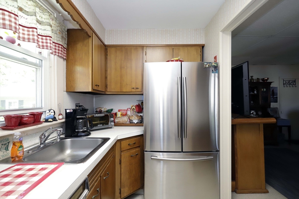 5 Anthony Street Acushnet, MA 02743 - Photo 21 of 37 a kitchen with a refrigerator a sink a stove and cabinets