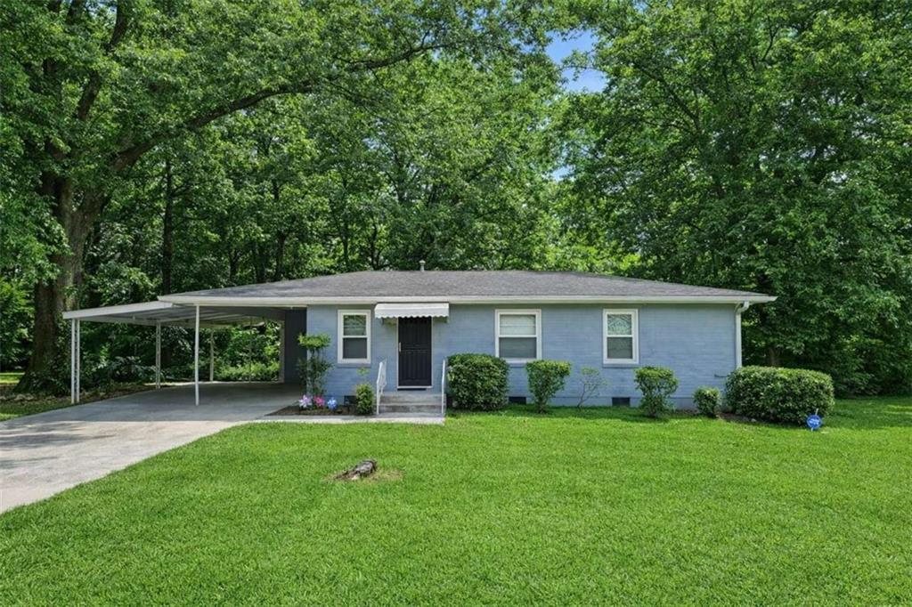 a view of a house with backyard sitting area and garden