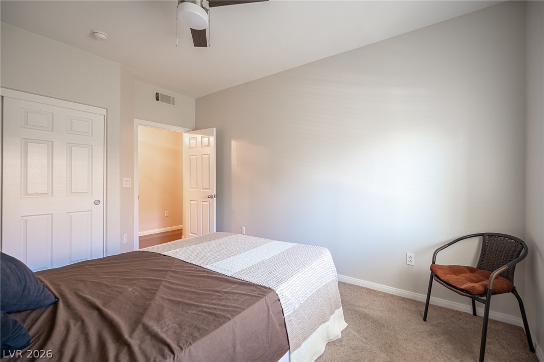 7701 West Robindale Road, Unit 274 Las Vegas, NV 89113 - Photo 27 of 43 A comfortable bedroom features plush carpet and a convenient sliding closet.