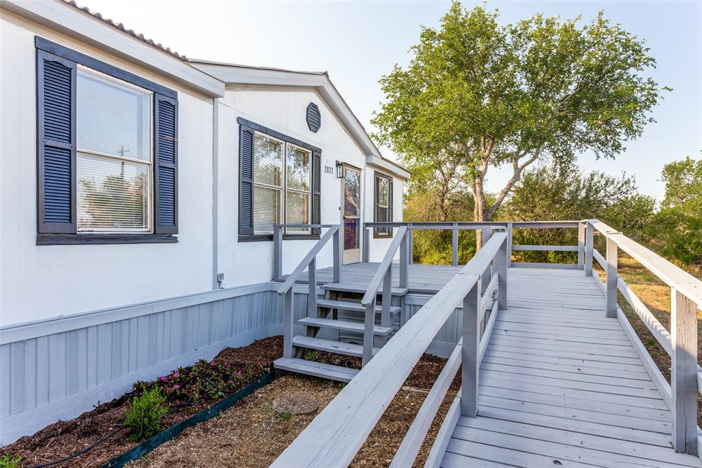 a view of a house with wooden deck