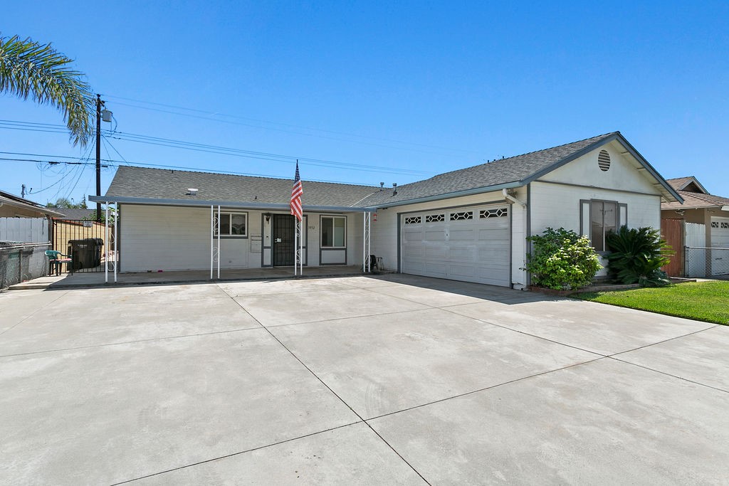 5932 Chinook Drive Huntington Beach, CA 92647 - Photo 3 of 5 a view of a house with a yard and palm trees
