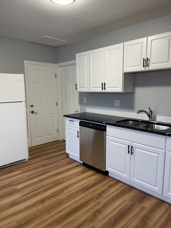12 Winslow Street Worcester, MA 01609 - Photo 4 of 15 a kitchen with granite countertop a sink cabinets and stainless steel appliances