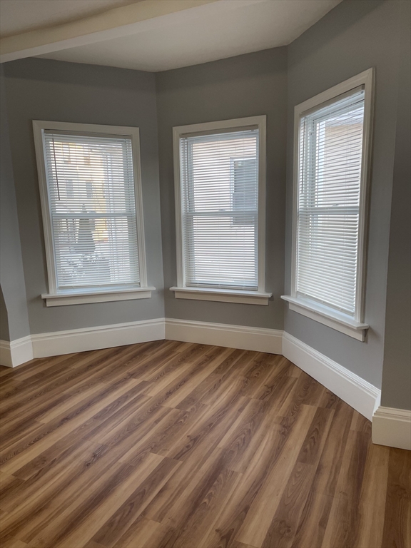 12 Winslow Street Worcester, MA 01609 - Photo 5 of 15 a view of an empty room with wooden floor and a window