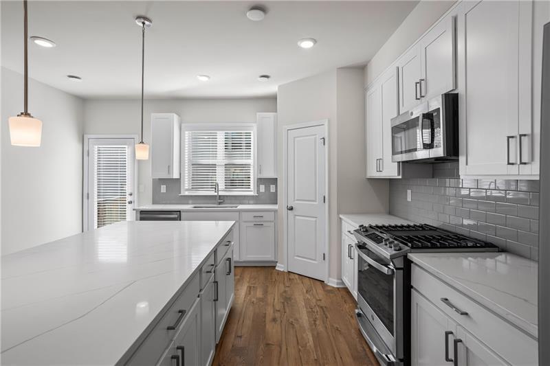 123 Matson Run Southwest Mableton, GA 30126 - Photo 12 of 32 a kitchen with stainless steel appliances granite countertop a sink stove and refrigerator