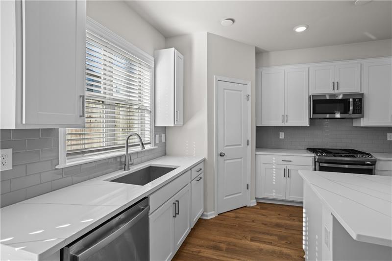 123 Matson Run Southwest Mableton, GA 30126 - Photo 13 of 32 a kitchen with granite countertop a sink stove and cabinets