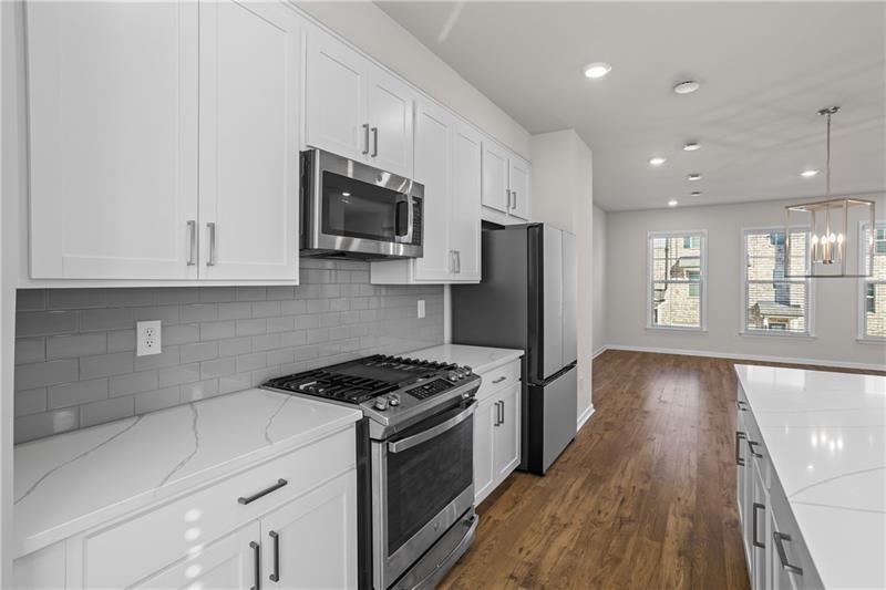 123 Matson Run Southwest Mableton, GA 30126 - Photo 14 of 32 a kitchen with granite countertop a stove a sink and a refrigerator