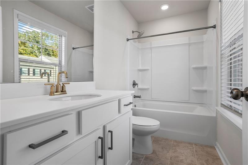 123 Matson Run Southwest Mableton, GA 30126 - Photo 25 of 32 a bathroom with a sink a toilet and a bathtub