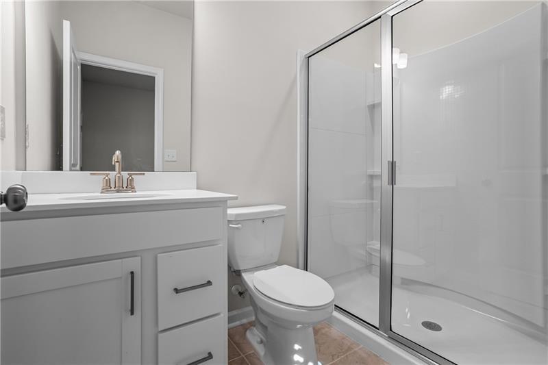 123 Matson Run Southwest Mableton, GA 30126 - Photo 27 of 32 a bathroom with a shower sink vanity mirror and toilet