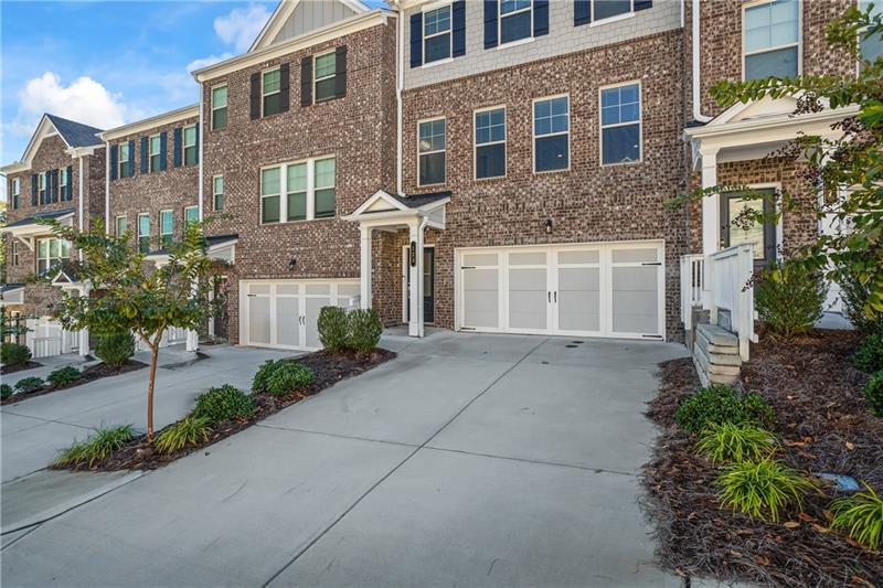 123 Matson Run Southwest Mableton, GA 30126 - Photo 4 of 32 a front view of a house with a yard and a garage