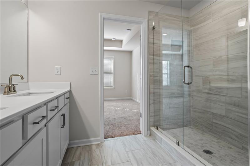 123 Matson Run Southwest Mableton, GA 30126 - Photo 9 of 32 a bathroom with a shower sink and mirror