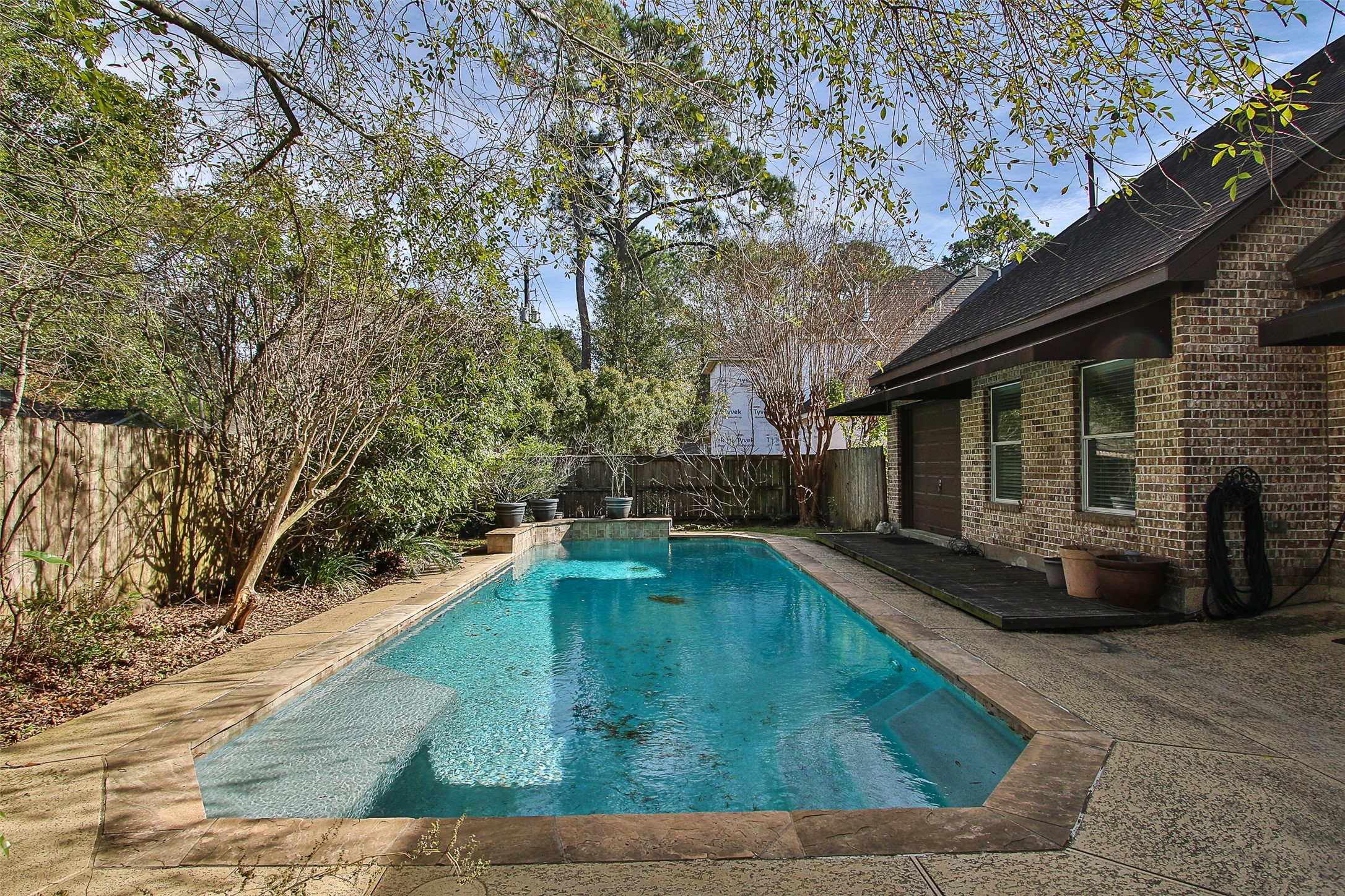 11722 Spriggs Way Houston, TX 77024 - Photo 45 of 49 Salt water pool has a tanning ledge and fountain