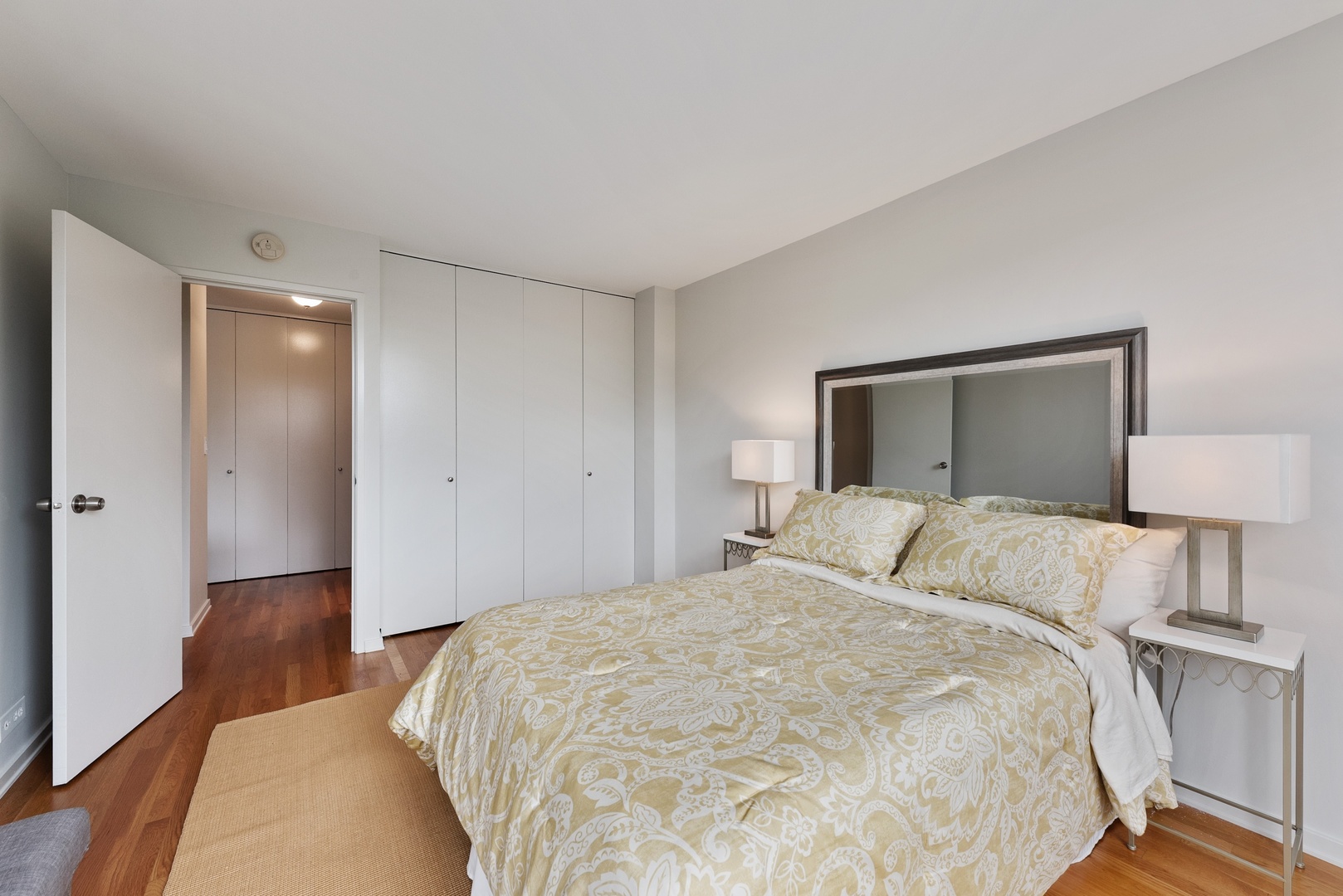 1920 North Clark Street, Unit 4B Chicago, IL 60614 - Photo 12 of 21 a bedroom with a bed and wooden floor