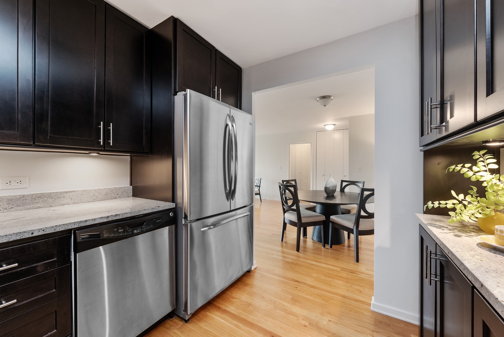 1920 North Clark Street, Unit 4B Chicago, IL 60614 - Photo 6 of 21 a kitchen with stainless steel appliances granite countertop a refrigerator and a stove top oven