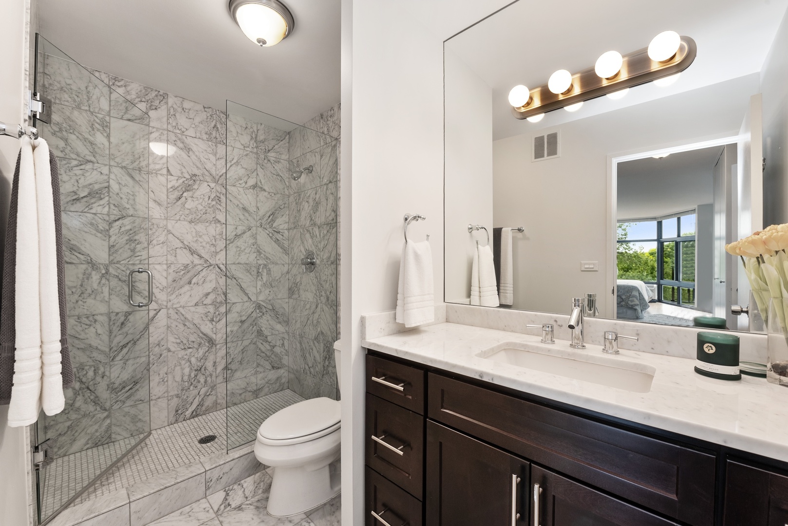 1920 North Clark Street, Unit 4B Chicago, IL 60614 - Photo 9 of 21 a bathroom with a sink a toilet and shower