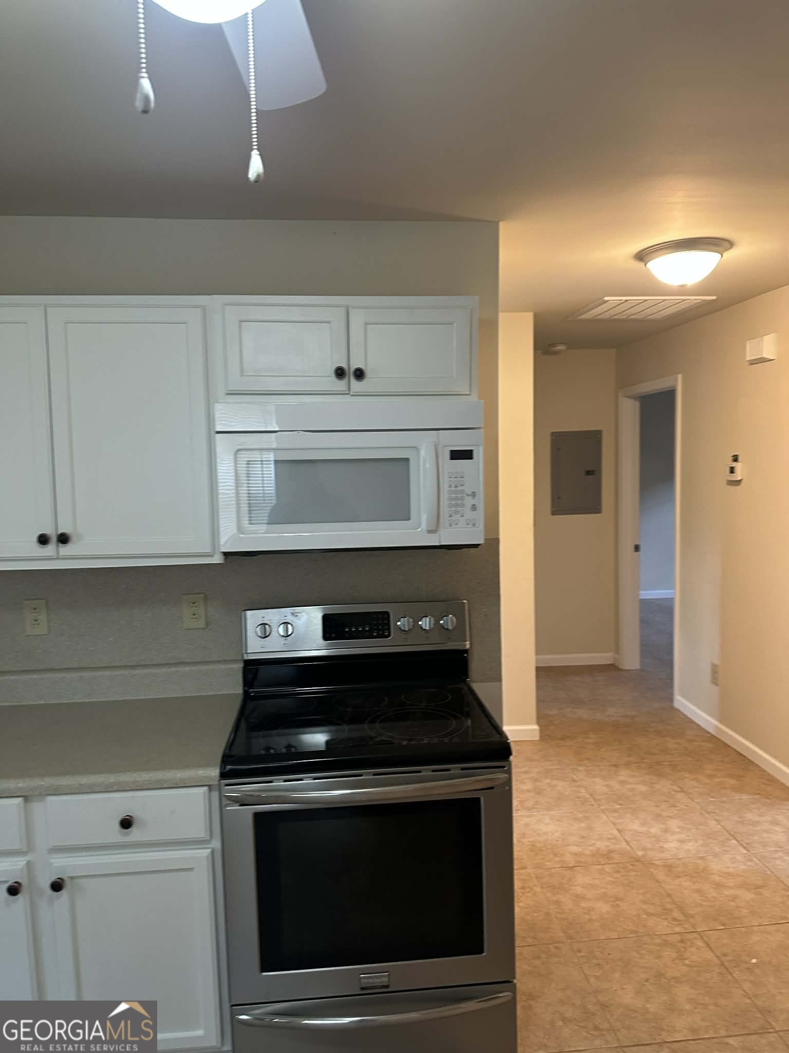1167 Turner Way, Unit A Macon, GA 31217 - Photo 4 of 10 a kitchen with a stove and white cabinets