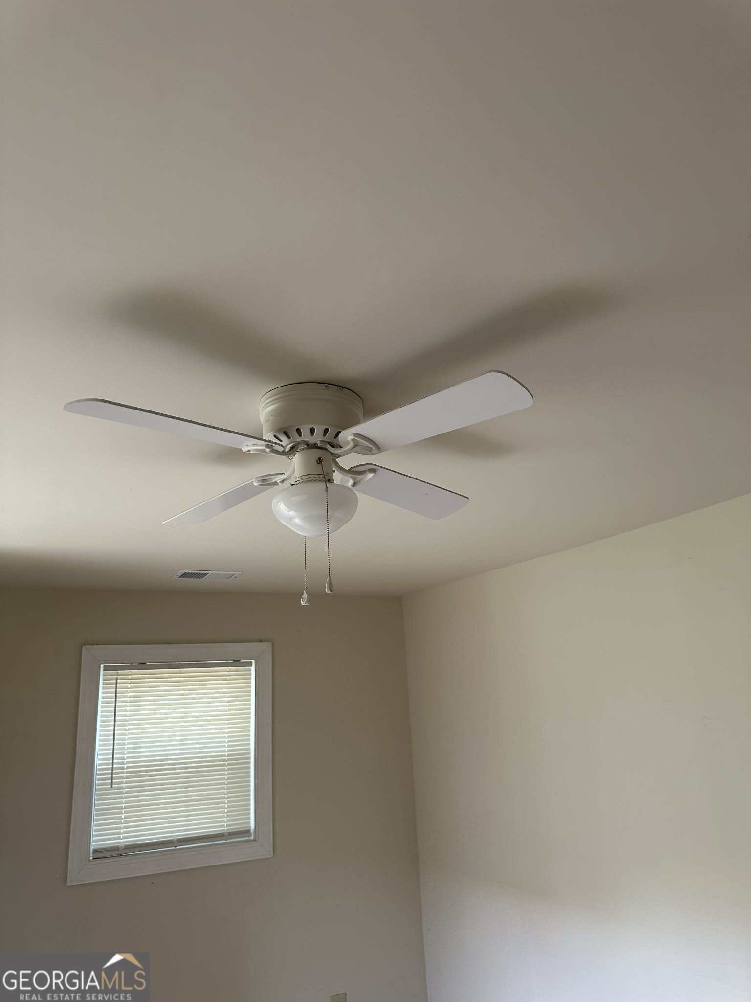 1167 Turner Way, Unit A Macon, GA 31217 - Photo 9 of 10 en empty room with windows and chandelier fan