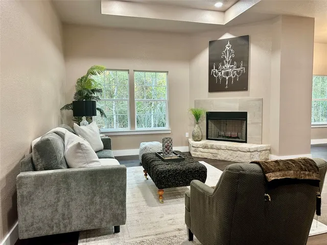 a living room with furniture and a fireplace