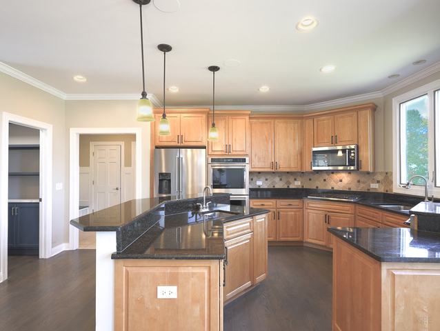 618 Pine Street Sugar Grove, IL 60554 - Photo 11 of 31 a kitchen with stainless steel appliances granite countertop a sink a stove and refrigerator