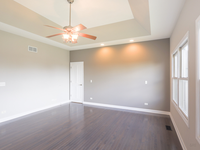 618 Pine Street Sugar Grove, IL 60554 - Photo 18 of 31 an empty room with wooden floor fan and windows