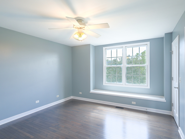 618 Pine Street Sugar Grove, IL 60554 - Photo 24 of 31 an empty room with wooden floor fan and windows
