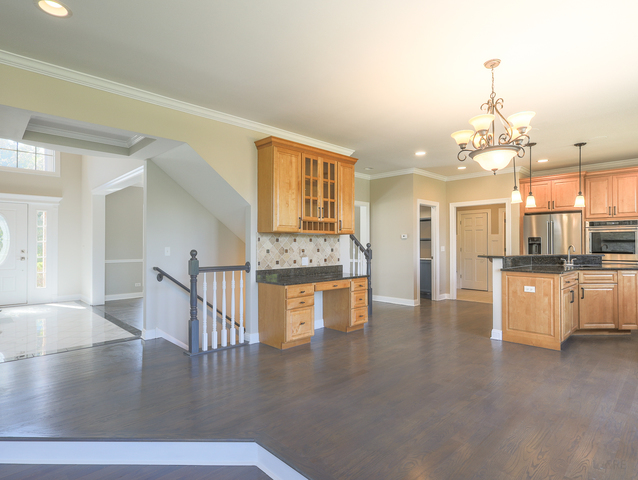 618 Pine Street Sugar Grove, IL 60554 - Photo 10 of 31 a view of a kitchen with kitchen island a counter top space a sink stainless steel appliances and cabinets