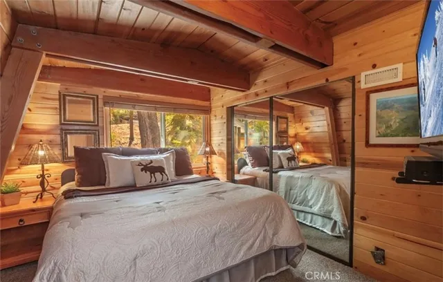 a bed sitting in a bedroom next to a window